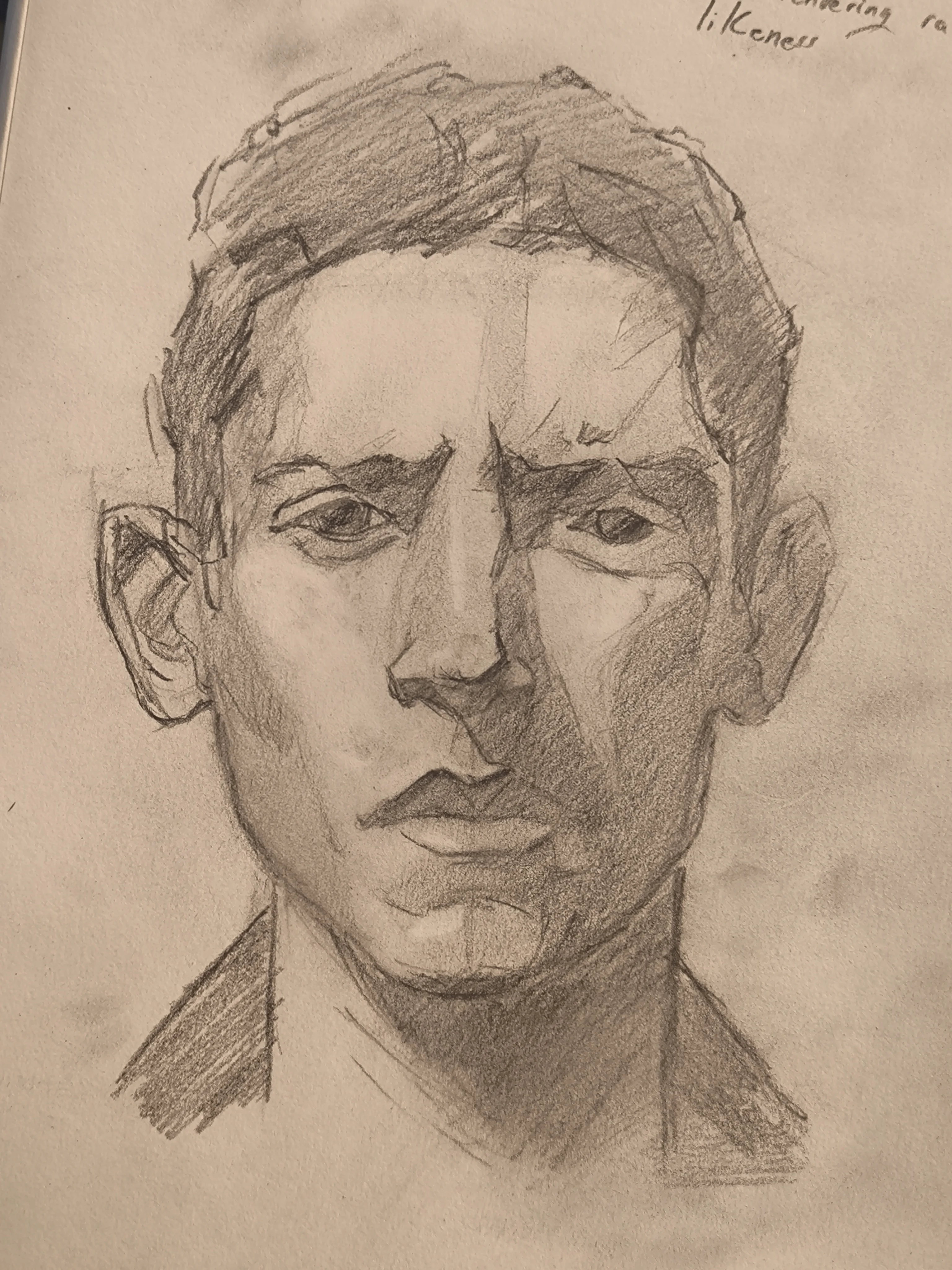 Graphite portrait sketch of a man with short hair. Front view.