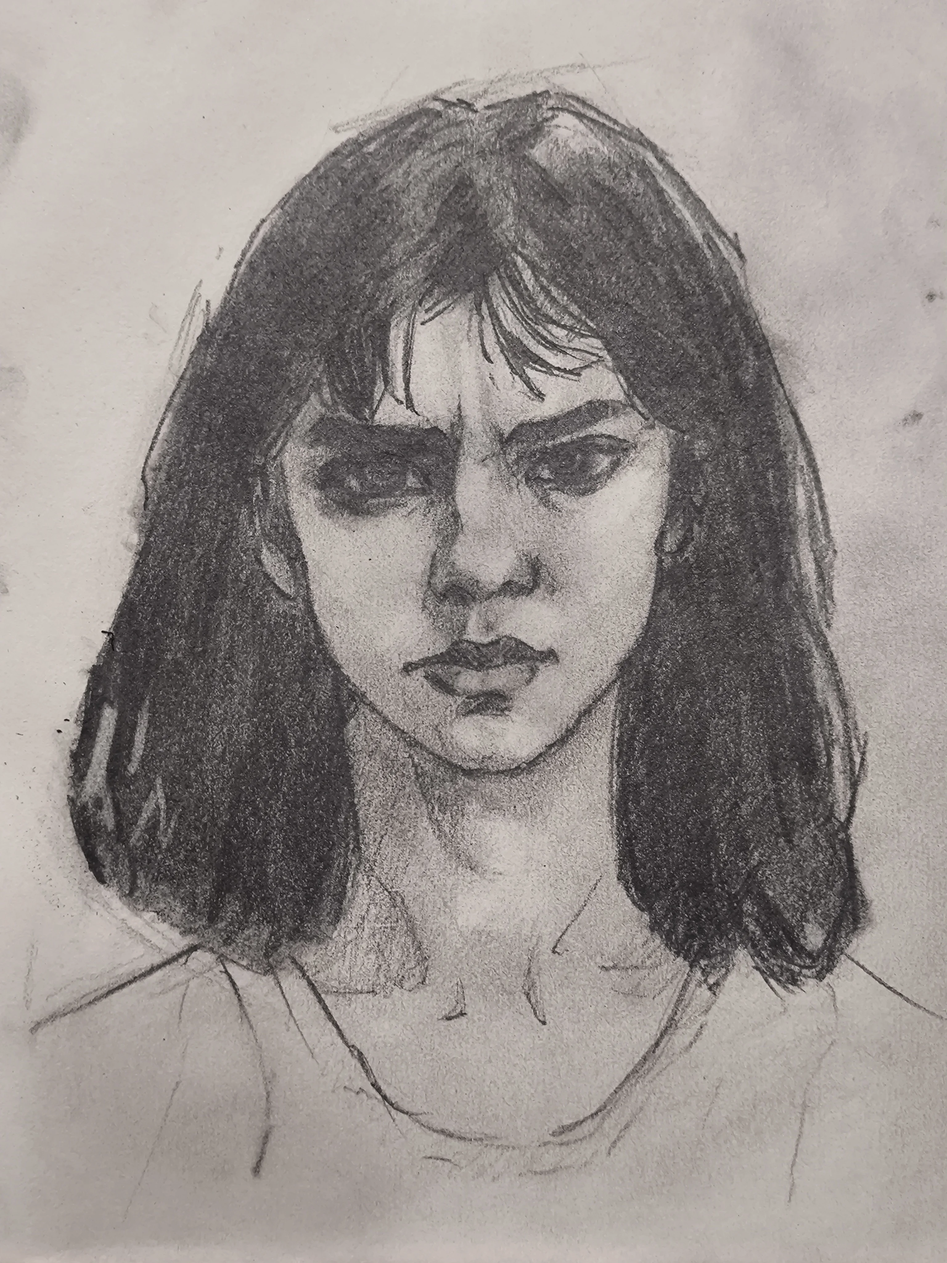 Graphite portrait sketch of a young woman, front view, with dark shoulder-length hair and bangs, a furrowed brow, and a serious expression. Strong shadowing around the eyes and cheeks with loose, sketchy clothing lines