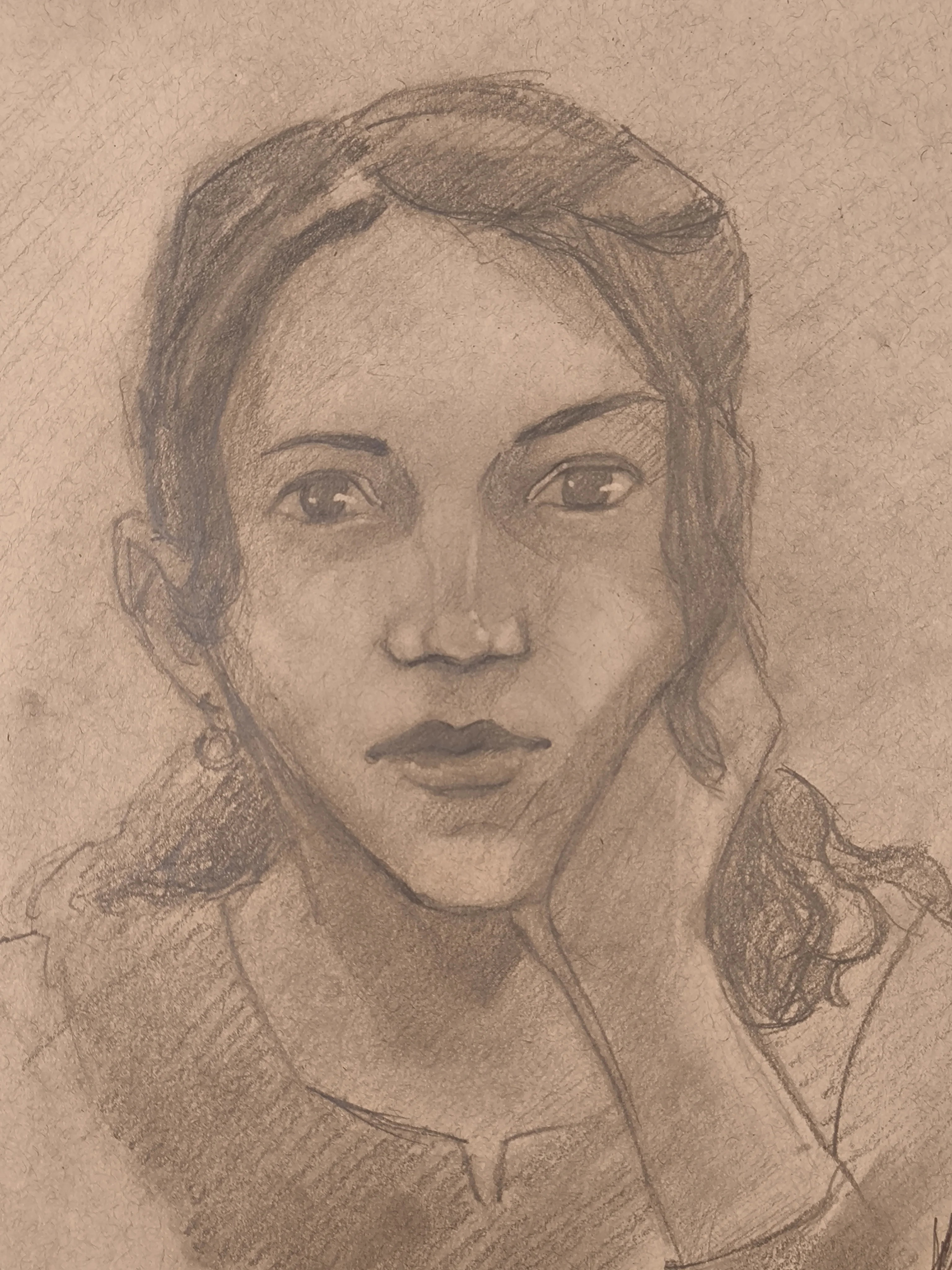Graphite portrait sketch of a woman looking straight at the viewer. She has dark hair pulled back with some loose strands, and sunglasses resting on top of her head. One hand supports her cheek, and she wears a small earring and a simple shirt, with soft shading around the eyes and neck.