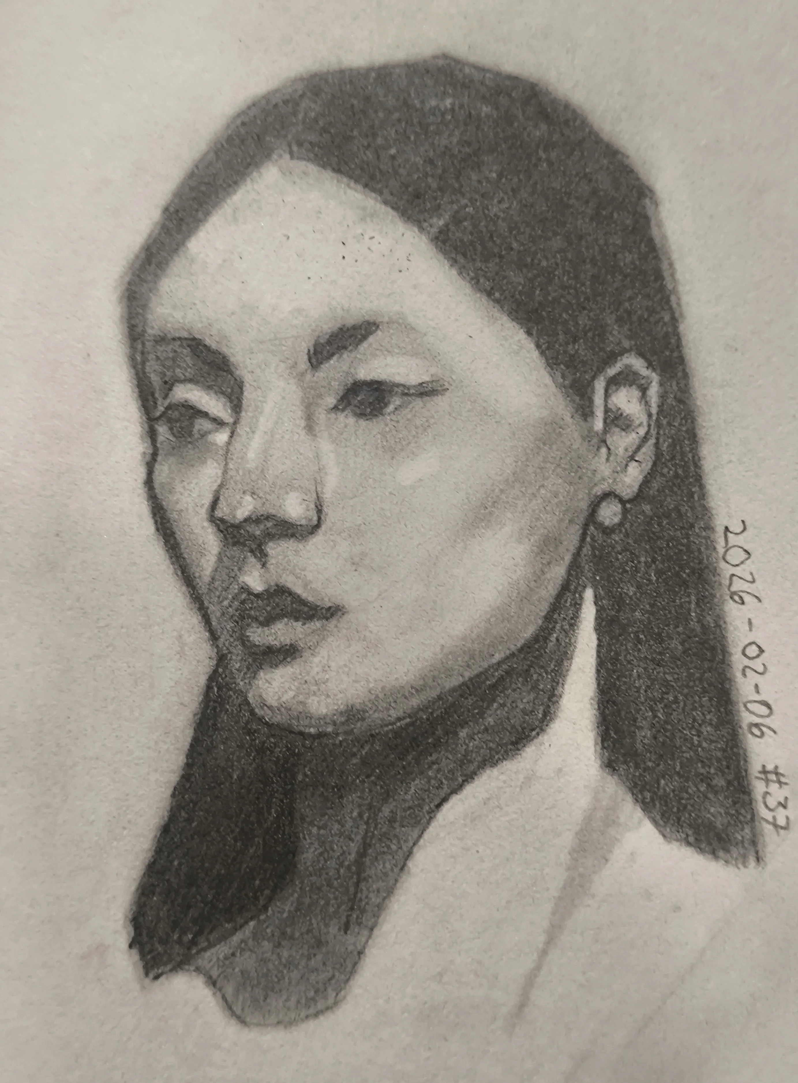 Graphite portrait of a woman in three-quarter view, looking to the left. She has long dark hair, winged eyeliner, and a small hoop earring. Soft shading defines the cheekbones and neck.