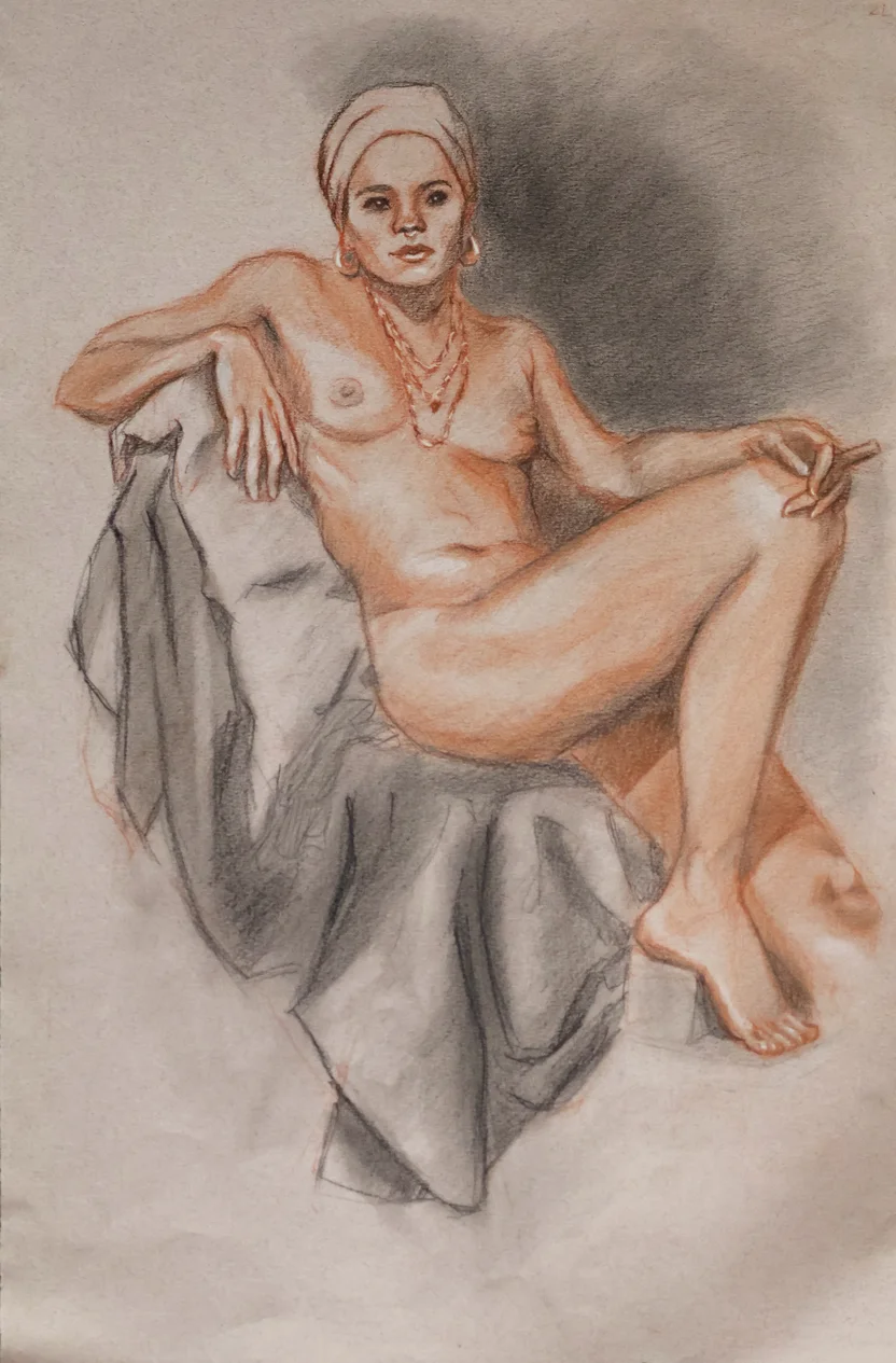 Reclining nude figure of a woman wearing headwrap and jewelry, drawn in red and dark pencil. She leans back on draped cloth, legs crossed, with soft shading and a calm, direct gaze.